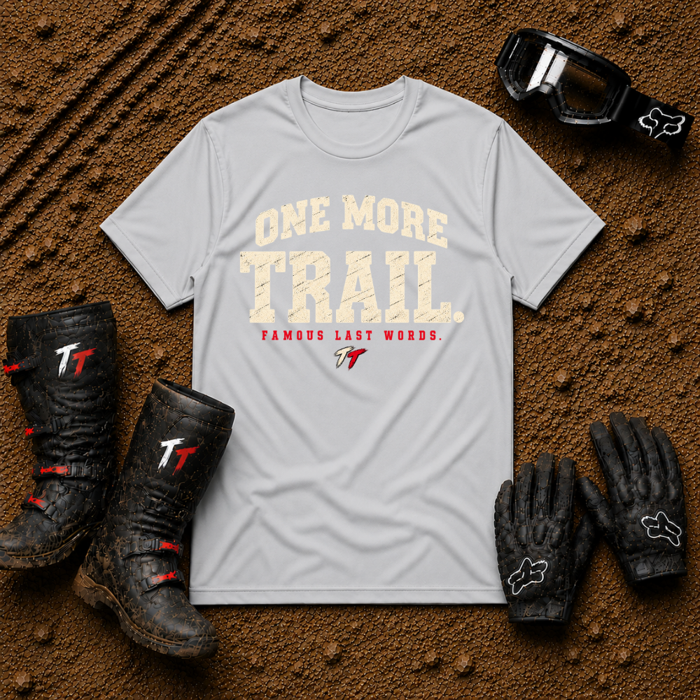 Sport Grey One More Trail t-shirt with vintage varsity print and 'Famous Last Words' tagline — flat lay with muddy boots, goggles, and gloves, Tire Time Offroad