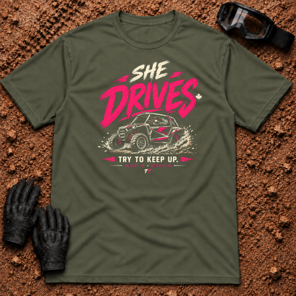 She Drives Try To Keep Up T-Shirt in Military Green - pink lettering over a woman driving a side-by-side UTV through dirt, Tire Time Offroad